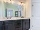 Bathroom featuring a double vanity, marble counters, a large mirror, and a walk-in shower at 4630 Socrates Way, Sanford, FL 32773