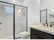 Bathroom with a glass-door shower, single vanity with granite countertop, and modern fixtures at 4630 Socrates Way, Sanford, FL 32773