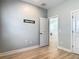 This bedroom has light gray walls, wood floors, and a door to another room at 4630 Socrates Way, Sanford, FL 32773