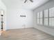 This bedroom has white walls, wood floors, and large windows with shutters at 4630 Socrates Way, Sanford, FL 32773