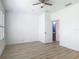This bedroom has a ceiling fan, wood floors, and an en suite bathroom at 4630 Socrates Way, Sanford, FL 32773