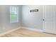 This bedroom has light gray walls, wood floors, and a large window at 4630 Socrates Way, Sanford, FL 32773