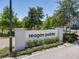 Well maintained sign and landscaping welcomes residents and visitors to Reagan Pointe under a clear, sunny sky at 4630 Socrates Way, Sanford, FL 32773