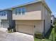 Close-up of an attached garage exterior with manicured landscaping and a well-maintained sidewalk at 4630 Socrates Way, Sanford, FL 32773