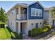 Two-story exterior showcasing neutral tones, a covered balcony, and a well-manicured front yard with landscaping at 4630 Socrates Way, Sanford, FL 32773