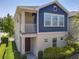 Charming two-story home featuring a blue accent wall, covered porch, and beautifully landscaped front yard at 4630 Socrates Way, Sanford, FL 32773