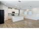 Open kitchen with a center island, stainless steel appliances, granite countertops, and modern white cabinetry at 4630 Socrates Way, Sanford, FL 32773