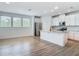 Bright, open kitchen with stainless steel appliances, granite counters, and an eat-in island at 4630 Socrates Way, Sanford, FL 32773