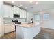 Bright kitchen featuring a center island with granite countertops, stainless steel appliances, and white cabinetry at 4630 Socrates Way, Sanford, FL 32773