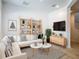 Bright living room with stylish decor, hardwood floors, decorative shelving, and comfortable seating arrangement at 4630 Socrates Way, Sanford, FL 32773