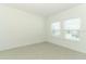 Bright bedroom features neutral colors, tile flooring, and two windows for ample natural light at 4724 Cloister St, Kissimmee, FL 34758