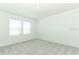Bright bedroom featuring neutral walls, carpet, and two windows at 4724 Cloister St, Kissimmee, FL 34758