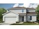 Charming two-story home with attached garage, landscaped yard and neutral color palette at 4724 Cloister St, Kissimmee, FL 34758