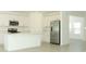 Bright kitchen featuring white cabinets, stainless steel appliances and center island at 4724 Cloister St, Kissimmee, FL 34758