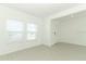 Bright living room offers tile floors and natural light from the two large windows at 4724 Cloister St, Kissimmee, FL 34758