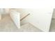Upstairs hallway with carpet, white walls, and wood railing at 4724 Cloister St, Kissimmee, FL 34758