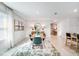A dining room featuring a wooden table, six green chairs, art decorations, and bright natural light at 4742 Yellow Elder Way, Kissimmee, FL 34758