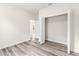 Bedroom featuring vinyl floors, a walk-in closet with wire shelving, and white walls and trim at 501 Marion Oaks Golf Way, Ocala, FL 34473