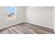 An empty bedroom with wood-look vinyl floors and a window at 501 Marion Oaks Golf Way, Ocala, FL 34473