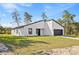 Attractive one-story home showcasing modern architectural design with a white exterior and black accents at 501 Marion Oaks Golf Way, Ocala, FL 34473