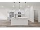 Open concept kitchen with stainless steel appliances, an island with pendant lights and wood-look flooring at 501 Marion Oaks Golf Way, Ocala, FL 34473