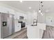 Bright kitchen featuring stainless steel appliances and a kitchen island with a dark faucet at 501 Marion Oaks Golf Way, Ocala, FL 34473
