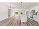 Open-concept kitchen features stainless steel appliances, white cabinets, and an island with pendant lighting at 501 Marion Oaks Golf Way, Ocala, FL 34473
