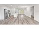 Bright open-concept living room features modern lighting, kitchen island, and stylish vinyl plank flooring at 501 Marion Oaks Golf Way, Ocala, FL 34473