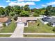 Aerial view of a well-kept single Gathering home in a neighborhood with mature trees and fenced yards at 5210 Poinsetta Ave, Winter Park, FL 32792