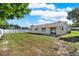 Large backyard featuring a patio, lawn, and perimeter fencing, perfect for relaxing or hosting activities at 5210 Poinsetta Ave, Winter Park, FL 32792