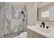 Modern bathroom featuring a tiled shower, hexagon tile floor, and a sleek vanity sink at 5210 Poinsetta Ave, Winter Park, FL 32792