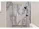 Beautifully remodeled bathroom shower with marble-look tile and modern matte black fixtures at 5210 Poinsetta Ave, Winter Park, FL 32792