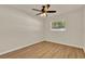 Bright bedroom with ceiling fan, wood floors, and natural light streaming through the window at 5210 Poinsetta Ave, Winter Park, FL 32792