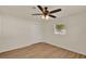 Comfortable bedroom with wood floors, ceiling fan, and a window and closet for convenience at 5210 Poinsetta Ave, Winter Park, FL 32792