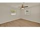 Inviting bedroom with wood floors, a ceiling fan, and two windows providing natural light at 5210 Poinsetta Ave, Winter Park, FL 32792