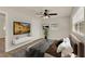 Comfortable bedroom features a ceiling fan, mounted TV, and plenty of closet space at 5210 Poinsetta Ave, Winter Park, FL 32792