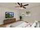 Comfortable bedroom features a ceiling fan, closet space, and a modern TV at 5210 Poinsetta Ave, Winter Park, FL 32792