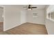 Well-lit bedroom featuring wood floors, ceiling fan, and a closet at 5210 Poinsetta Ave, Winter Park, FL 32792