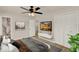 Bedroom featuring a ceiling fan, mounted TV, and an open doorway at 5210 Poinsetta Ave, Winter Park, FL 32792
