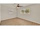 Cozy bedroom featuring wood flooring, two windows and a ceiling fan at 5210 Poinsetta Ave, Winter Park, FL 32792