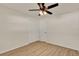 Neutrally decorated bedroom featuring wood floors, a ceiling fan, and a double-door closet at 5210 Poinsetta Ave, Winter Park, FL 32792