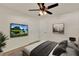 Inviting bedroom with ceiling fan, and mounted TV for comfortable relaxation at 5210 Poinsetta Ave, Winter Park, FL 32792