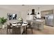Dining room with marble-topped table, kitchen island with seating, and stainless steel refrigerator at 5210 Poinsetta Ave, Winter Park, FL 32792