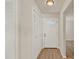 Bright entryway with a white front door, closet, and wood-look floors, creating a welcoming first impression at 5210 Poinsetta Ave, Winter Park, FL 32792