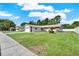 Inviting single-Gathering home with a lush lawn and a classic design surrounded by trees and a white fence at 5210 Poinsetta Ave, Winter Park, FL 32792