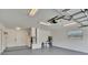 Spacious garage with painted floor, lighting, water heater, and ample space for storage and parking at 5210 Poinsetta Ave, Winter Park, FL 32792