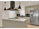 Modern kitchen with stainless steel appliances, a center island, stylish pendant lighting, and a black backsplash at 5210 Poinsetta Ave, Winter Park, FL 32792