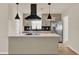 A renovated kitchen with an island, modern pendant lighting, and stainless steel appliances at 5210 Poinsetta Ave, Winter Park, FL 32792