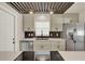 Updated kitchen featuring modern range hood, stylish cabinets, quartz countertop and stainless steel appliances at 5210 Poinsetta Ave, Winter Park, FL 32792