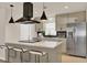 Bright kitchen with stainless steel appliances, large island, and pendant lighting at 5210 Poinsetta Ave, Winter Park, FL 32792